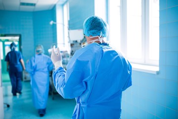 Rear view of surgeon walking in operation room