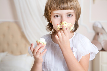 Cute little girl eating cake.

