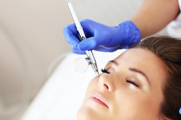 Woman having facial treatment in beauty salon
