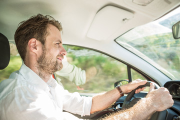 Forty years old caucasian man driving a car