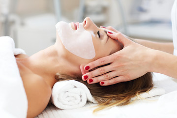 Woman with facial mask in beauty salon