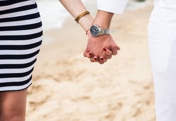 Beautiful young pregnant woman with man on the beach feel peace and tranquility