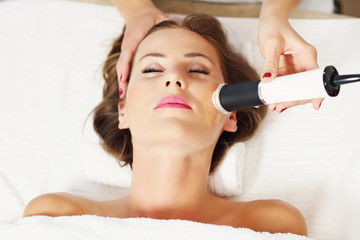 Woman having facial peeling in beauty salon