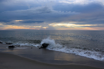 Sunrise Above Wave Splashing into Jetty