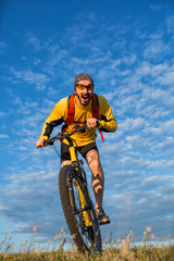 Man in helmet and glasses stay on the bicycle