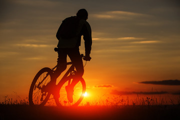 Fototapeta na wymiar Silhouette of a bike on sky background