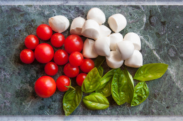 Ingredients for italian caprese salad with mozzarella, tomatoes and basil