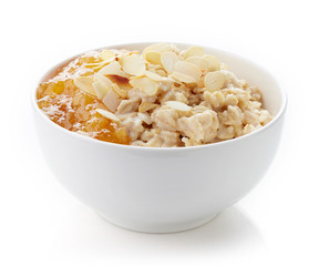 Bowl of healthy oatmeal isolated on white