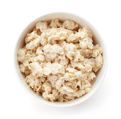 Bowl of healthy oatmeal isolated on white, from above