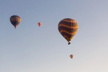 Hot air balloon flying over rock landscape at Cappadocia Turkey