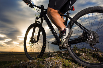 Fototapeta na wymiar Closeup of cyclist man legs riding mountain bike