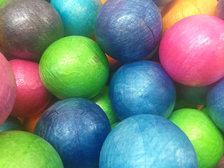 Multi colored, highly saturated plastic balls, in soft-play ball-pit, at a child's play-park, top down viewpoint