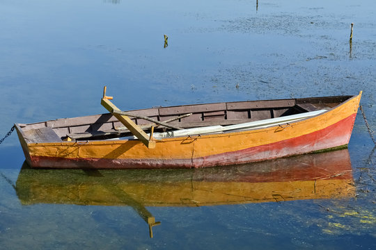 Anchored yellow rowboat