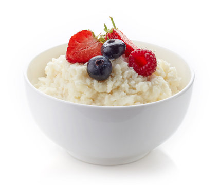 Bowl of rice flakes porridge isolated on white