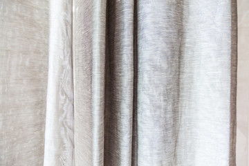 Beige curtains at the windows