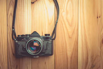 Retro camera on wood table background , vintage