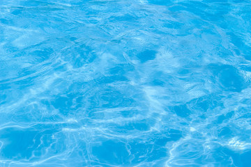 Blue pool water with sun reflections