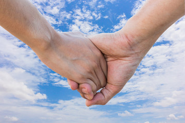 Lover hold hand on blue sky with cloud