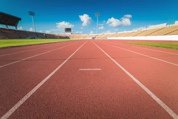 Tuinposter Red running track in stadium © FocusStocker