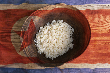 Poverty concept, bowl of rice with North Korea flag