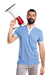 Man with blue shirt shouting by megaphone