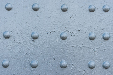 Bluish gray painted surface with rivet heads