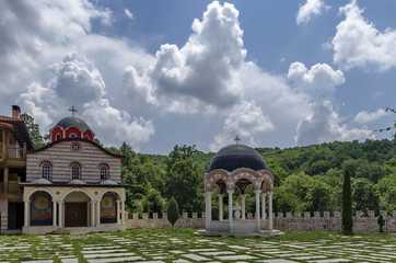 View of inner  part yard with new monastic house, alcove  and new church, in restored Montenegrin or Giginski monastery  St. St. Cosmas and Damian, mountain  Kitka, Breznik, Pernik region, Bulgaria 