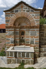 View of inner  part yard with  spring water fountain in restored Montenegrin or Giginski monastery  St. St. Cosmas and Damian, mountain  Kitka, Breznik, Pernik region, Bulgaria 