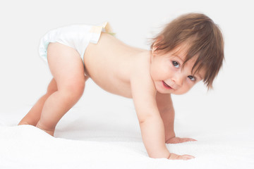Bright picture of crawling baby girl in diaper.