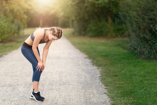 Sportliche Frau hat Schmerzen beim Laufen