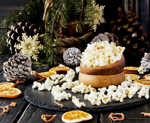 popcorn in a wooden plate on the background of Christmas