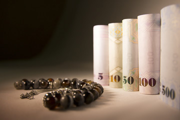 Rounded Cash Money on Satin Cloth with Rosary