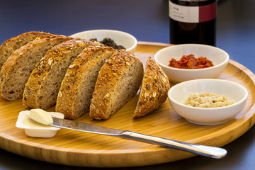 Fresh sliced country style whole grain bread with a mix of spreads and butter