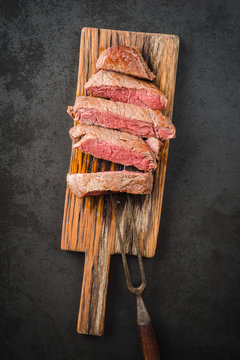 Sous Vide Cooked And Seared Fillet Steak On Rustic Wooden Board