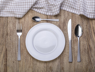 Empty plate with fork and knife
