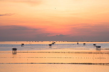 Fototapeta premium sunrise over fisherman village by the sea