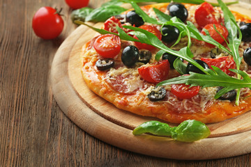 Tasty pizza with vegetables, herbs on wooden background