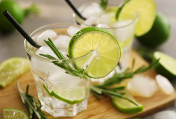 Cold fresh cocktails with lime on cutting board