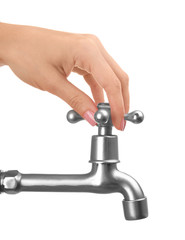 Female hand turning tap isolated on white. Water saving concept
