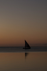 Fototapeta na wymiar Dhow sailing over the sunset at Bazaruto Island, Mozambique