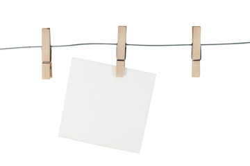 Wooden clothespin / Wooden clothespin and blank paper on white background.