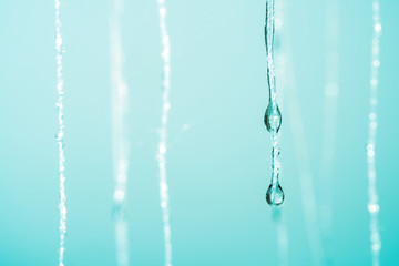 Naklejka na ściany i meble Water droplet / Closeup of water droplet on thread. Blue tone.