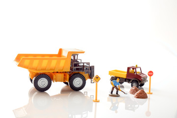 Construction toy / View of construction site of mini toy worker on white background.