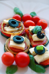 Grilled zucchini slices with tomatoes, black olives, goat cheese and basil