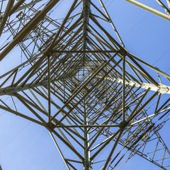 electric pylons transporting electricity through high tension ca