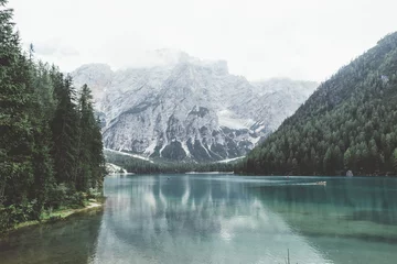 Foto op Canvas Braies lake with green water and mountains with trees   © walterquiet