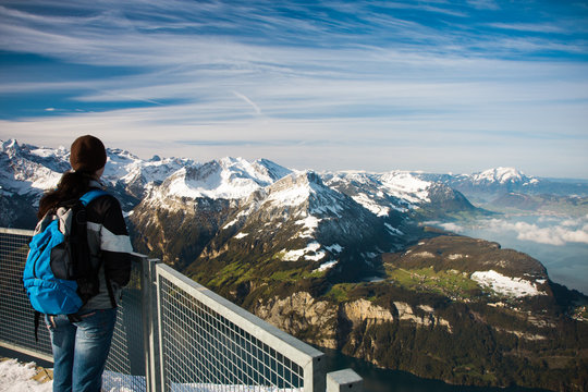 Young girl watching from the Frontalpstock peak to the Lake Lucerne, Central Switzerland