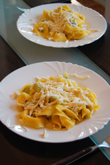 Ravioli filled with spinach and ricotta, Italian egg pasta, with fresh goat cheese on top