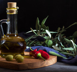 Olive oil in a bottle, horizontal, front view, dark photo