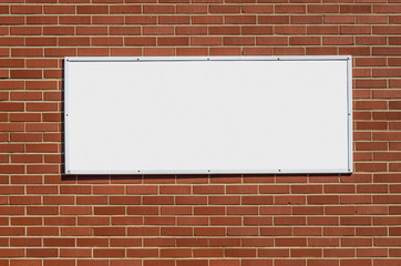 Blank White Sign for your Copy on Brick Wall